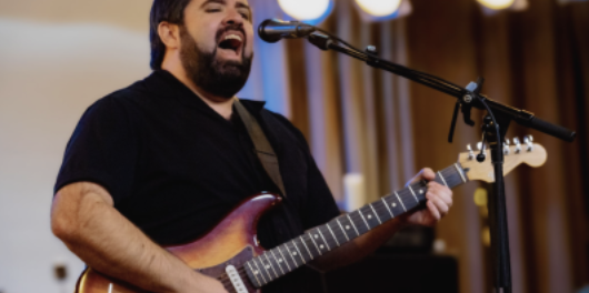Man playing guitar and singing